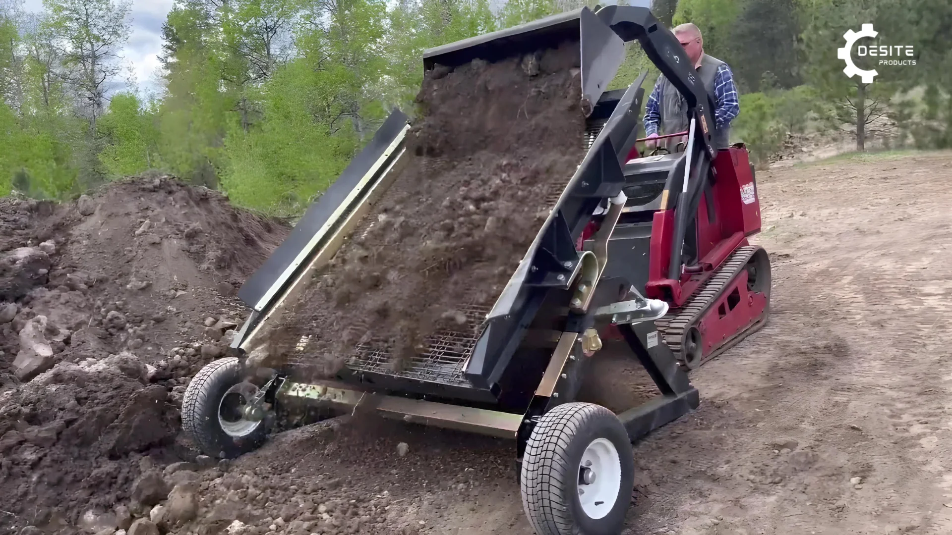 Front view of DeSite SLG 48 Topsoil and Rock Screener with stand-on skid steer efficiently screening 8 yards of material.