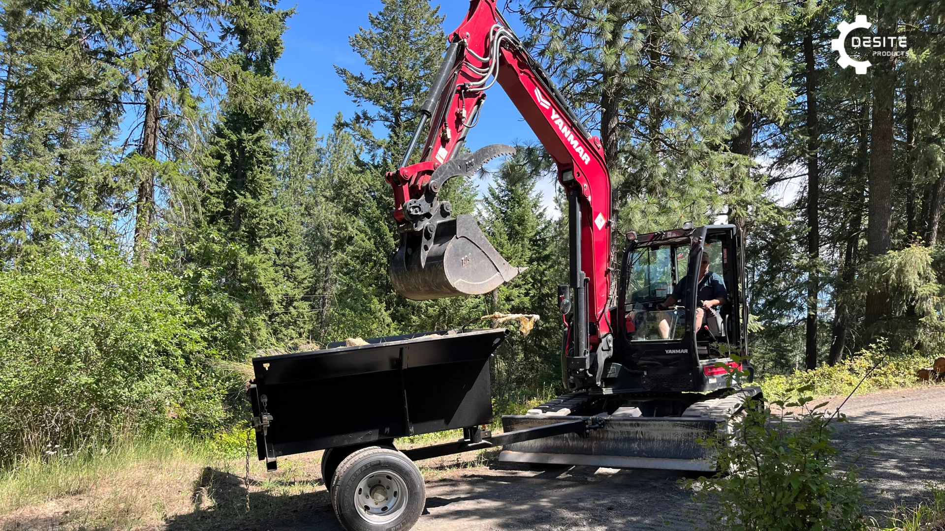 Front view of DeSite Xtreme Duty Dump Trailer with an excavator efficiently transporting materials.